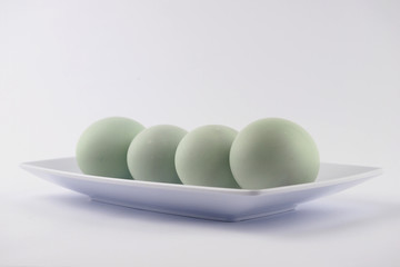 Serving fresh duck eggs on a white background