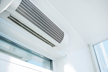 Large household air conditioning in a bright room. Device for adjusting the indoor climate. Copy space