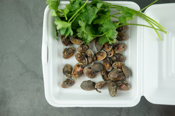 Fresh and delicious boiled​ cockles​ shell eating in foam box.