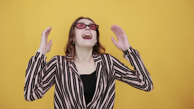 Cute Young Woman Light Brown In Striped Pink, Black Shirt On A Yellow Background, The Girl Enthusiastically Made New Idea, Forefinger Turned Up