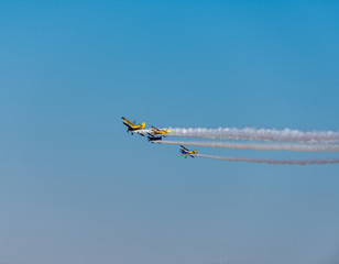 Airplanes on airshow. Aerobatic team performs flight at air show