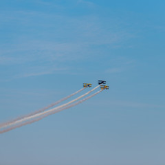 Airplanes on airshow. Aerobatic team performs flight at air show