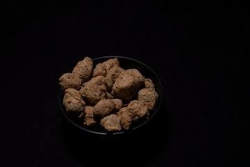 Top down image of a bowl of soya chunk in a dark copy space background. Food and product photography.