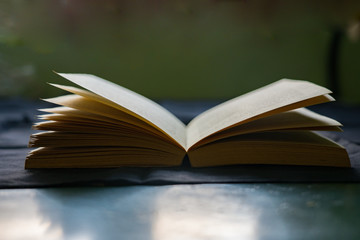 An open book with visible pages in a low light