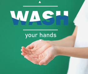 Young woman and text WASH YOUR HANDS on color background