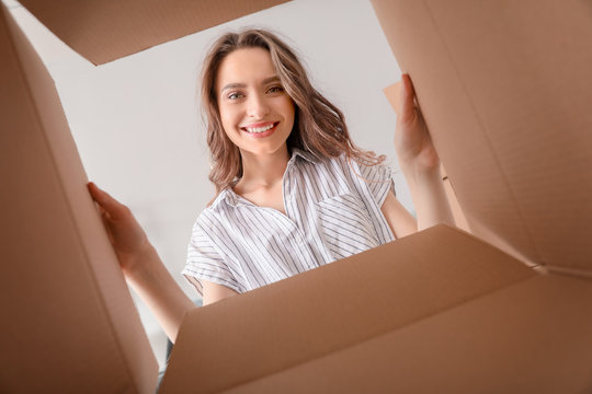 Happy woman with open box, view from inside