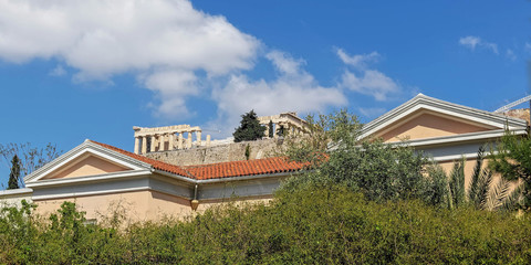 Athens Greece, parthenon temple on acropolis hilll and partiail view of neoclassiccal building pediment