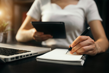 business documents on office table with smart phone and digital tablet and graph financial and man working