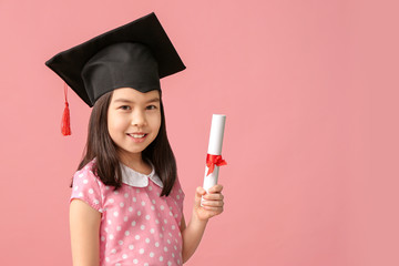 Little girl in graduation hat and with diploma on color background