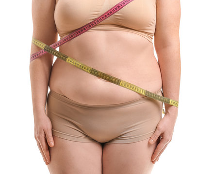 Overweight woman with measuring tapes on white background, closeup. Weight loss concept
