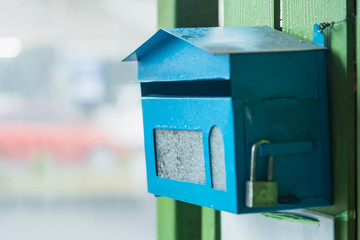 The blue mail box in front of the house