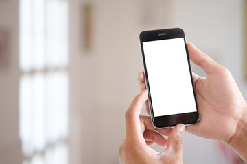 Cropped shot view of man hands holding smart phone with blank copy space screen for your text message or information content, female reading text message on cell telephone during in urban setting. 