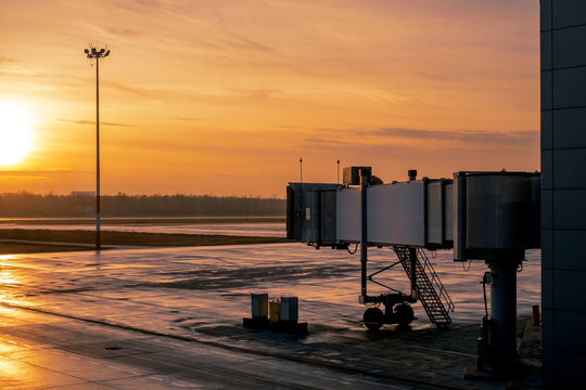 A Quiet And Empty Airport With A View Of The Taxiway And The Airplane Tube