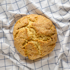 Homemade Irish Soda Bread on cloth, overhead view. Flat lay, top view, from above.