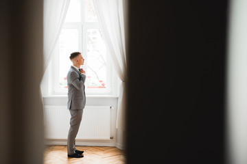 Young handsome man relaxing at his apartment in a hotel after business meeting