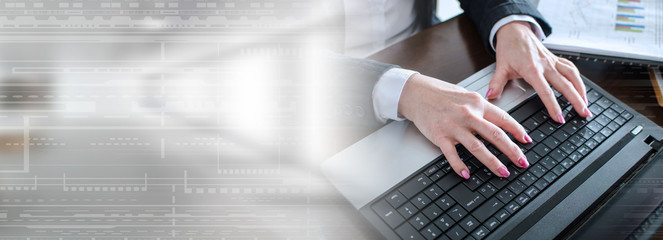 Businesswoman typing on a laptop; panoramic banner