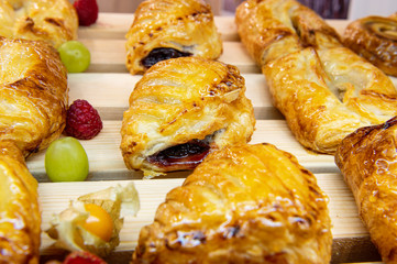 Sweet toppings with filling. The rolls are coated with sugar icing.