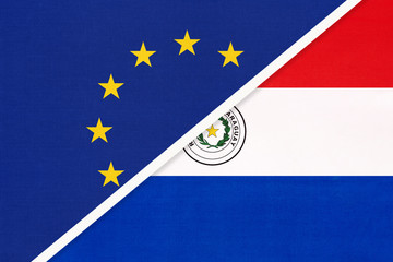 European Union or EU vs Paraguay national flag from textile. Symbol of the Council of Europe association.