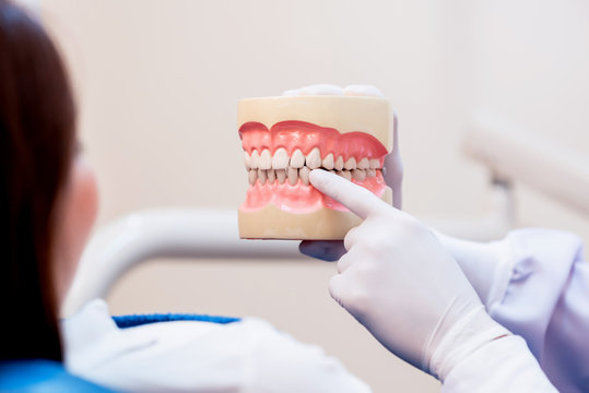 Dentistry and teeth healthcare concept at dental clinic. Dentist check-up teeth for young asian patient.