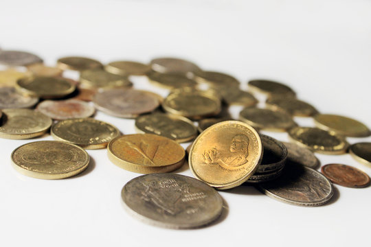 Indian Old vintage coins. Indian old and new coins isolated on white background.  Valid and invalid Indian currencies. Chanakya five rupee coin highlighted.