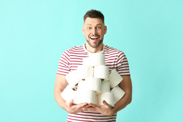 Happy man with toilet paper on color background. Concept of coronavirus epidemic