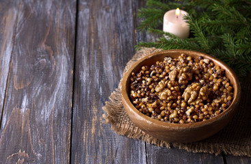 Sochivo, kutya - traditional Slavic holiday ritual dish (Russian, Ukrainian, Belarusian) of whole wheat, poppy, walnuts and honey in wooden bowl on wooden table