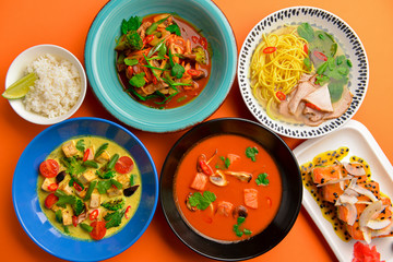 Asian food. Ramen soup with noodles, chicken stir fry and vegetables ingredients with spices, sauces, sushi.