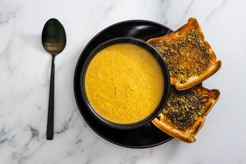plant-based food, vegan carrot and potato soup with pesto garlic bread
