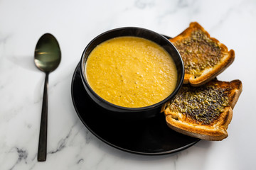 plant-based food, vegan carrot and potato soup with pesto garlic bread