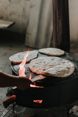 Person bakes traditional Turkish gozleme, specifically Turkish cake, street food. traditional turkish bread bazlama new baked