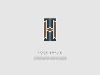 a two-colored rectangular business logo which has the letters h and t and a diamond shape in the middle 