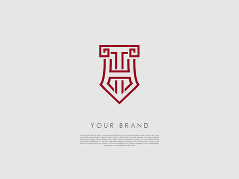 a red business logo that looks like a crest and has representations of an ancient column, tip of a pencil, letter h and t