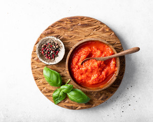 Sauce ajvar on a wooden cutting board, view from above