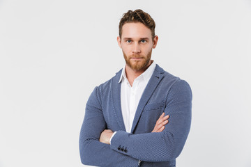Image of pleased young man posing on camera with hands crossed