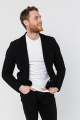 Image of unshaven pleased man in jacket smiling and looking aside