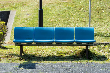 Blue bench at the bus stop. 