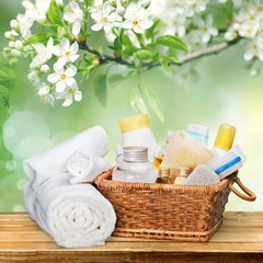 Obraz na płótnie Canvas Bath towel and basket with accessories for spa on desk