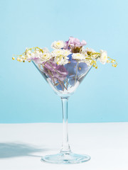 A bouquet of flowers in a wine glass. Creative concept of winemaking.