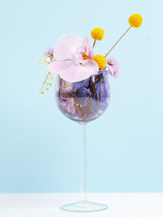 A bouquet of flowers in a wine glass. Creative concept of winemaking.
