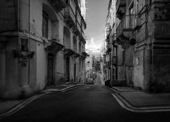 Narrow streets and old walls of the city of Valletta fortress. The capital of the island state is Malta. Black and white