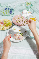 Delicate decorative flowers on plates. Creative concept of table serving and healthy eating