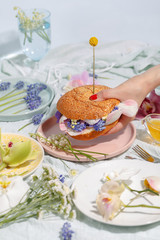 Burger of delicate flowers. Creative concept of healthy eating