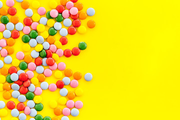 Color candy on yellow tabe top-down frame space for text