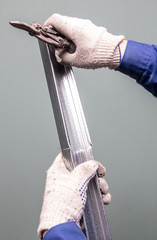 Worker cuts a metal profile for the walls.