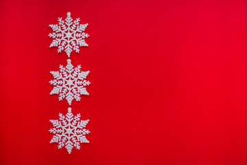 White snowflakes on a red background.