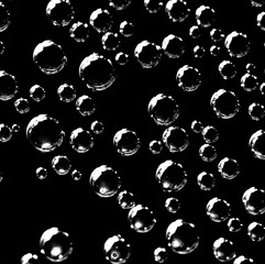 Air balls in water on a black background