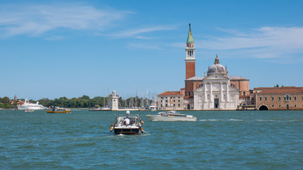 Boats go in front of the Church of San Giorgio Maggiore. Venice Italy.