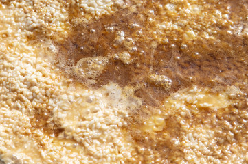 Pilaf with rice is cooked on a cast-iron cauldron.