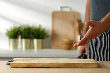 Wooden table in the kitchen with incoming morning sunlight with free space for an advertising product