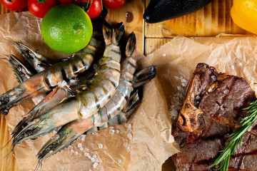 Fresh raw tiger prawns on the garden table. Surf and turf concept